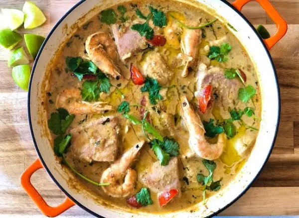 Goan fish curry with fish steaks in a red coconut gravy, garnished with coriander and green chillies