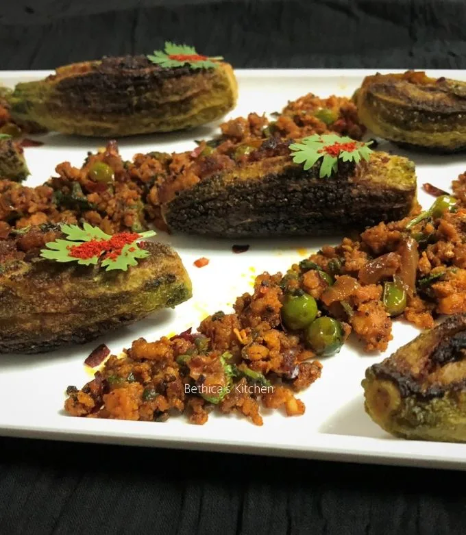 A karahi of keema karela with browned bitter gourd pieces in spiced beef mince, topped with coriander and ginger